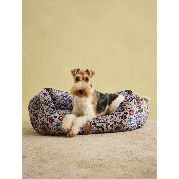 Fox Terrier laying on Joules Festival Floral Box Bed