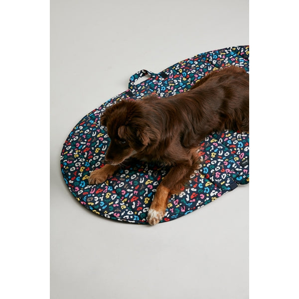 Dog laying on Joules Multi-Bee Print Travel Mat