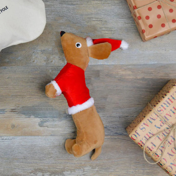 Santa Sausage Dog Toy among presents